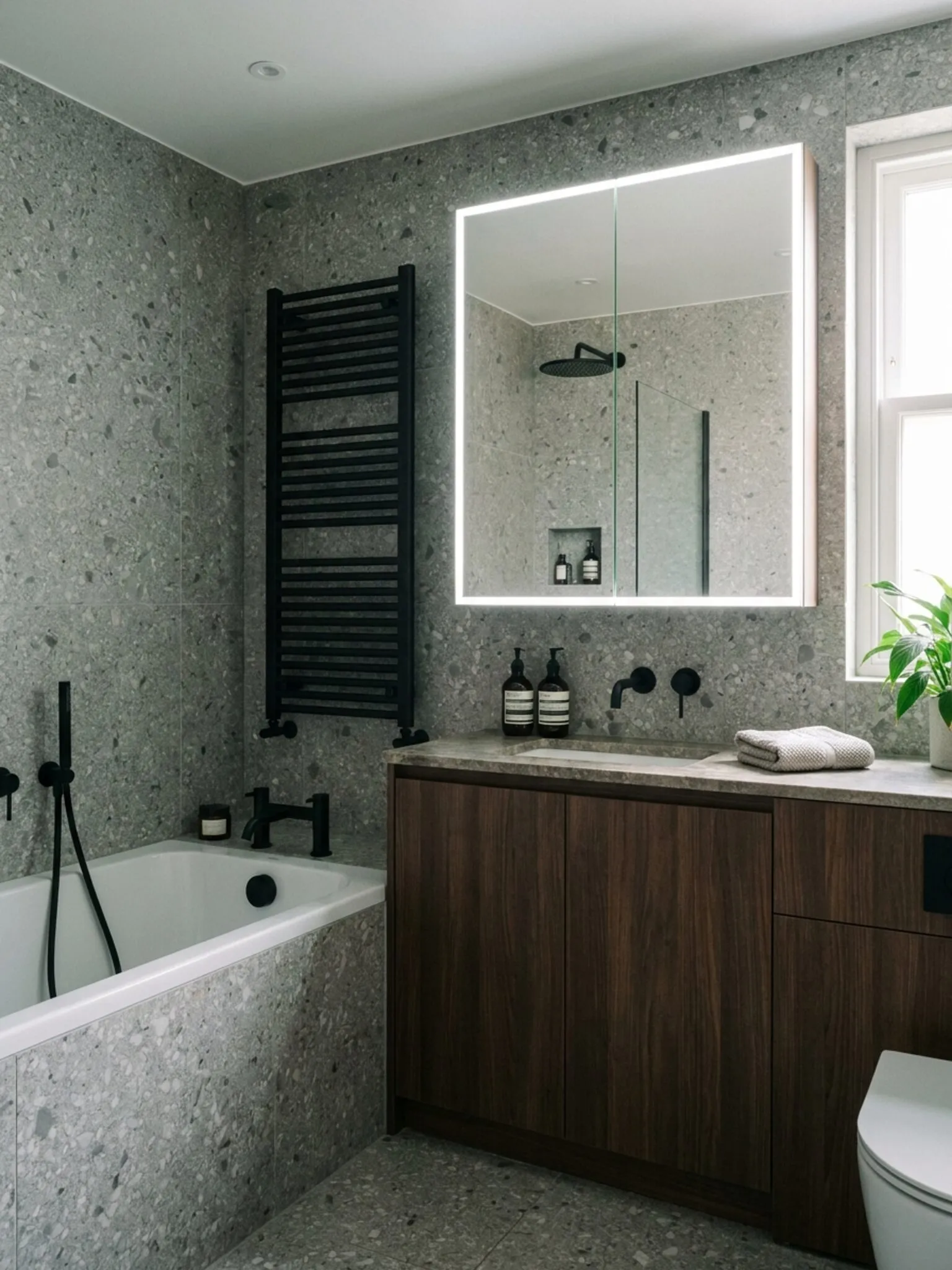 Corner view of bath, radiator, mirror and vanity